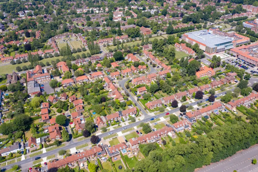 Aerial photo of the British town of Stevenage in Hertfordshire UK showing a typical British housing estate with rows of houses in the village, on a hot sunny summers day.